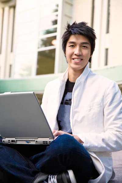 Asian male student and laptop — Stock Photo, Image