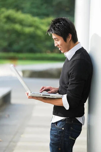 Asian student and laptop — Stock Photo, Image