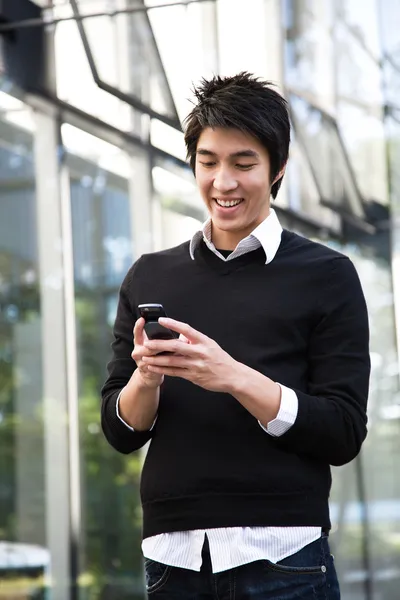 Asian man texting — Stock Photo, Image