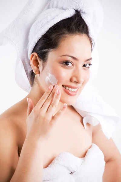Beautiful asian woman with lotion — Stock Photo, Image