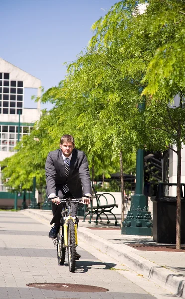 Caucasian businessman riding a bicycle