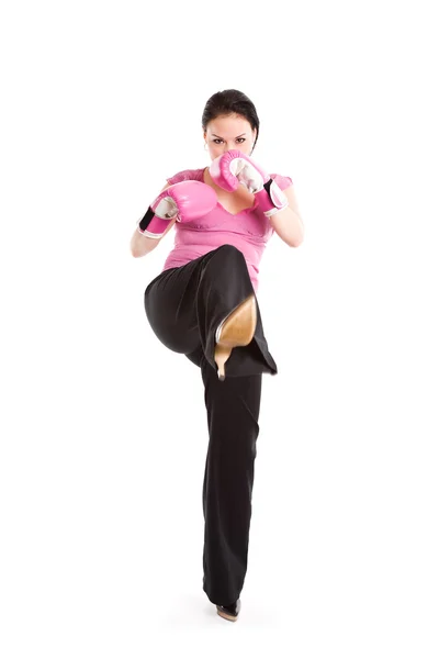 Kicking businesswoman with boxing gloves — Stock Photo, Image
