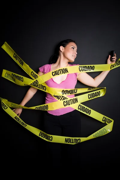 Businesswoman trapped in caution tape — Stock Photo, Image