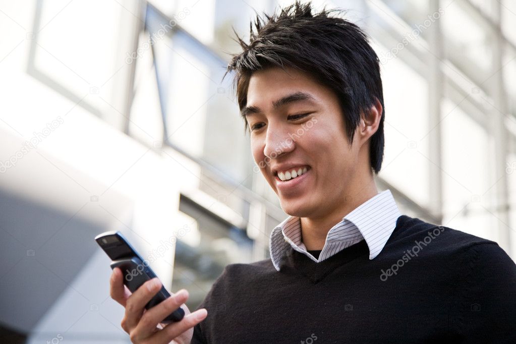 Casual asian businessman texting