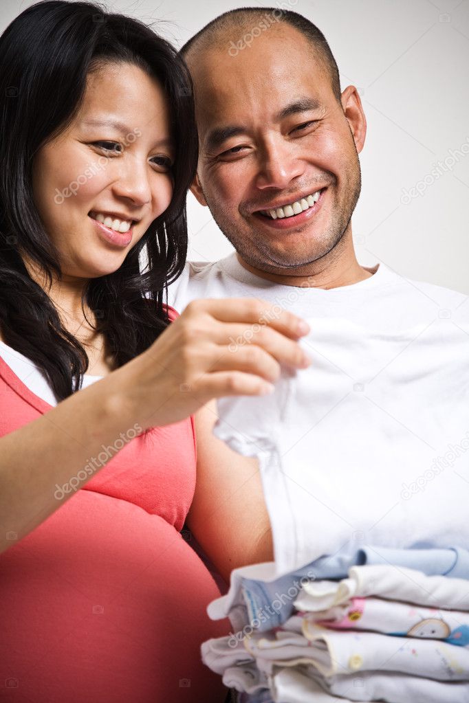 Happy expecting asian couple