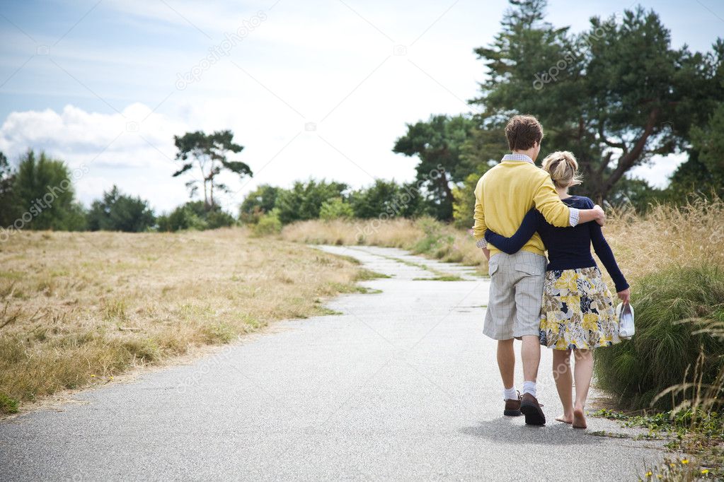 Young caucasian couple walking in a park