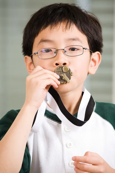 Winning boy kissing medal — Stock Photo, Image
