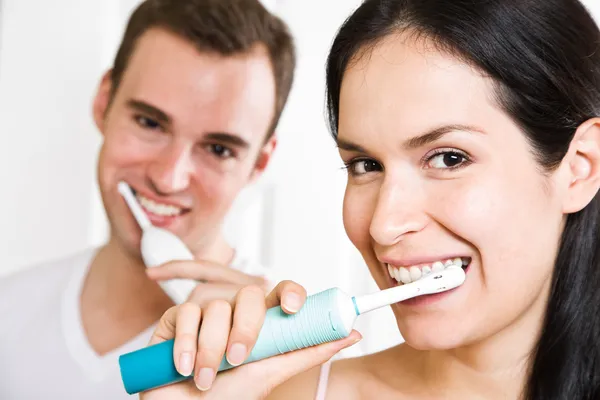 Couple brushing teeth in the bathroom — Stock Photo, Image