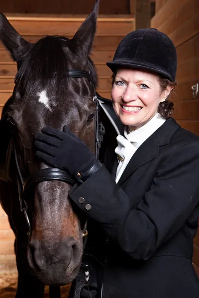 Senior woman with her horse — Stock Photo, Image