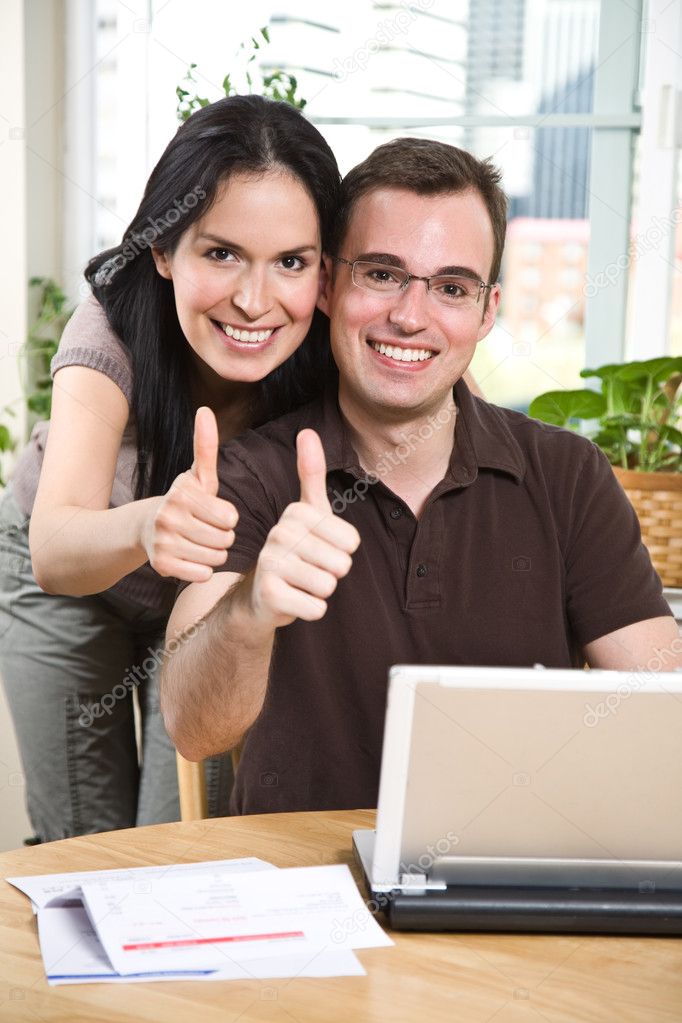 Happy couple giving thumbs up