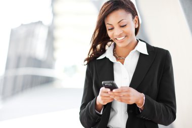 Black businesswoman texting clipart