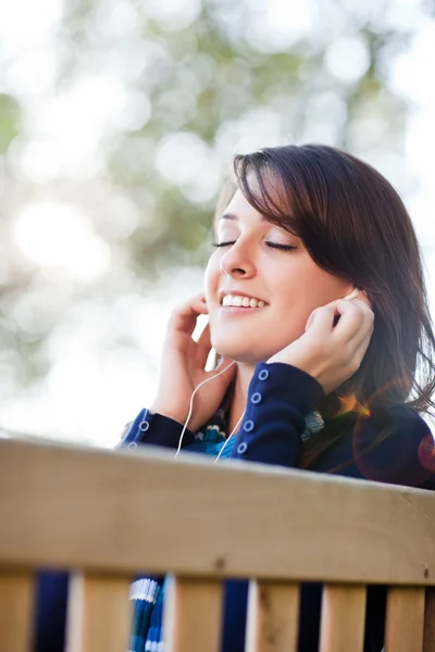 Mixed race ollege student listening to music — Stock Photo, Image