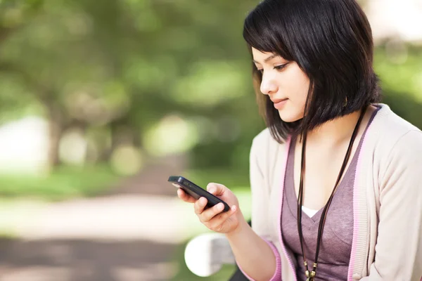 Mixed race student texting — Stock Photo, Image