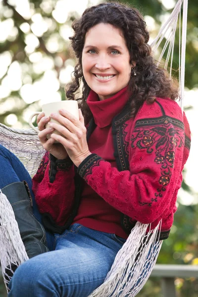 Mature woman drinking coffee Stock Image