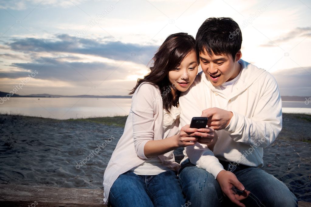 Asian couple texting