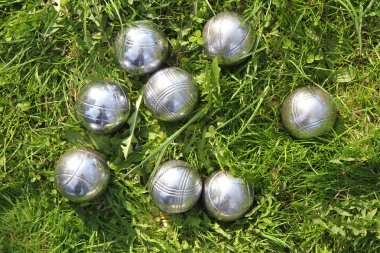 Petanque bowls in the green grass clipart