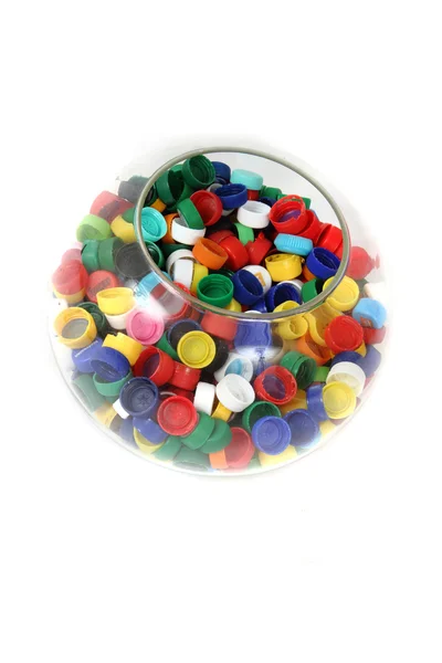 Plastic caps in the glass sphere — Stock Photo, Image