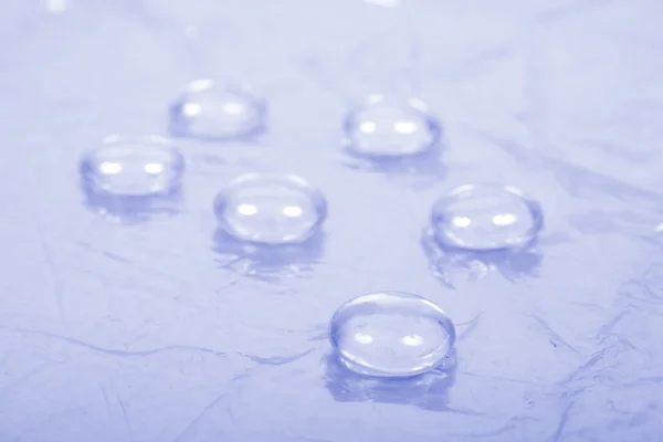 Stock image Water drops on blue background