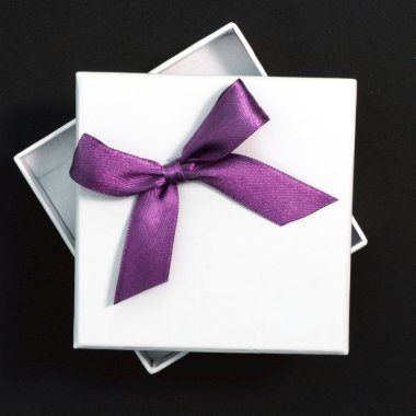 White gift with purple ribbon clipart