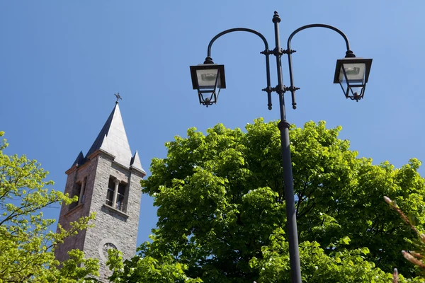 Kilise kulesi ve mavi gökyüzü ve yeşil ağaçlar fener — Stok fotoğraf