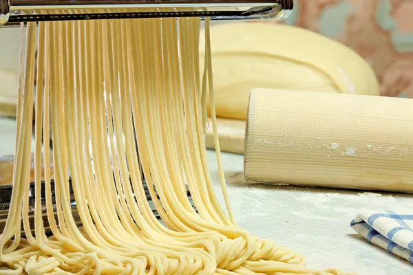 Noodles and pasta machine. Stock Photo