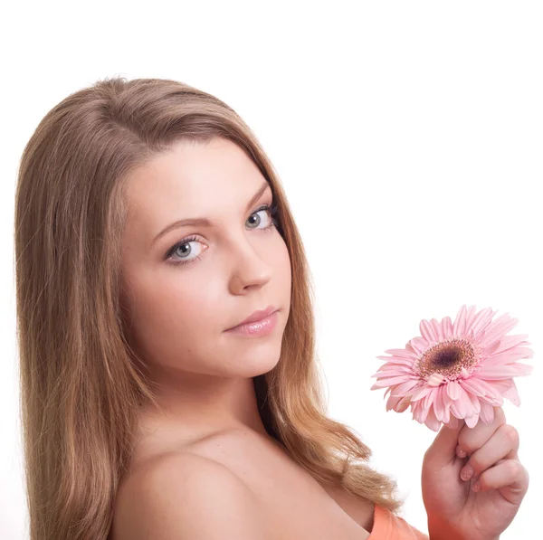 Closeup of a pretty young woman smelling a pink flower — Stock Photo, Image