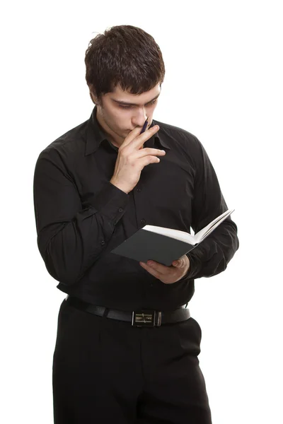 本と白い背景で隔離のペンを持つ男 — ストック写真