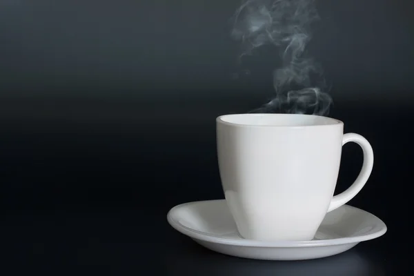 White cup with hot liquid and steam — Stock Photo, Image