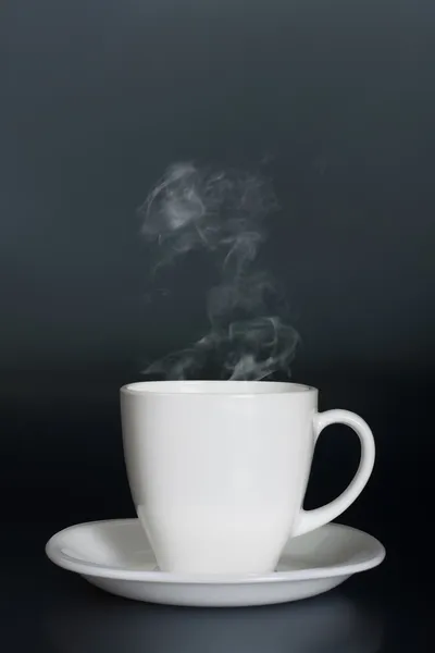White cup with hot liquid and steam — Stock Photo, Image