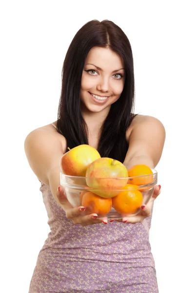 Happy woman holding a dish with fruits on white background — Stock Photo, Image