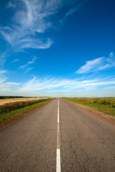 stock image Summer landscape with rural road and cloudy sky