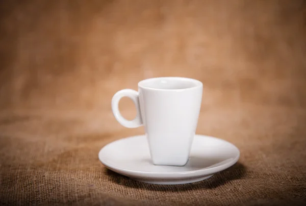 White coffee cup on sacking — Stock Photo, Image