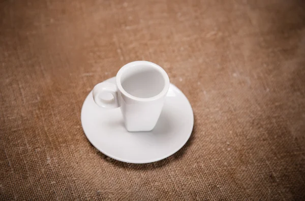 White coffee cup on sacking — Stock Photo, Image