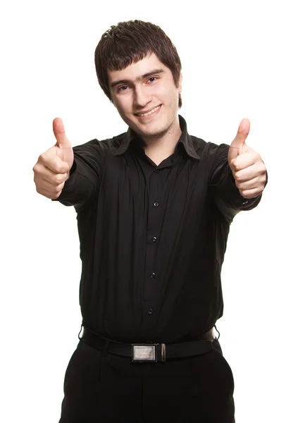 Portrét mladého muže, v černé košili směřují palce up podepsat ag — Stock fotografie