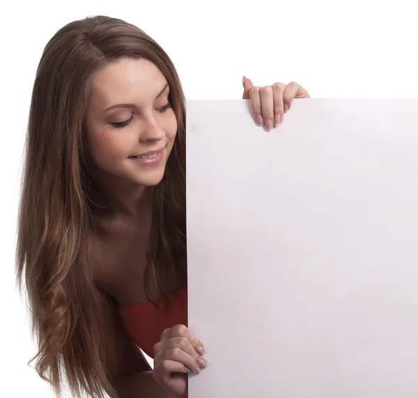 Young woman looking down a white sign — Stock Photo, Image