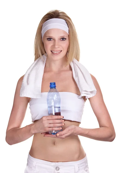Atractiva deportista sonriente con una botella de agua mineral —  Fotos de Stock