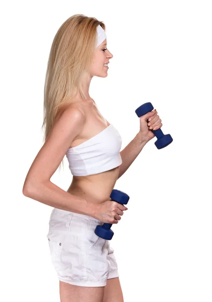 Portrait of a smiling sporty woman with a dumbbell on white back — Stock Photo, Image