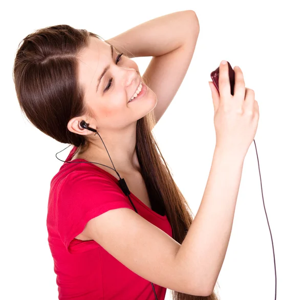 Attractive smiling teen girl listen music on white background — Stock Photo, Image