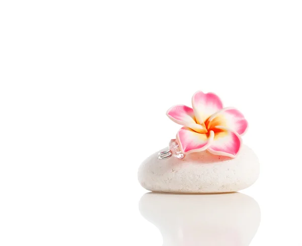 Flower brooch on stone — Stock Photo, Image