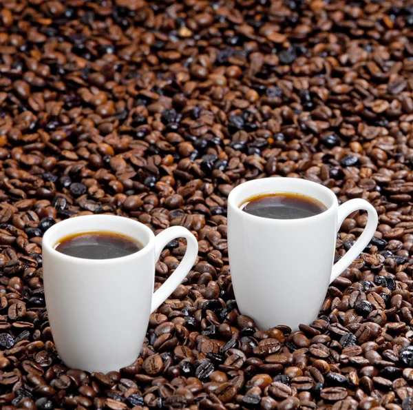 Натюрморт из кофейных чашек и кофейных зерен — стоковое фото
