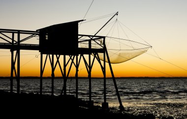 Pier with fishing net during sunrise, Gironde Department, Aquita