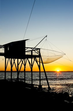 Pier with fishing net during sunrise, Gironde Department, Aquita