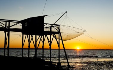 Pier with fishing net during sunrise, Gironde Department, Aquita