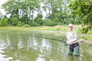 Woman fishing in pond clipart