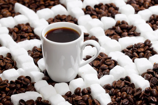 Cup of coffee with coffee beans and sugar — Stock Photo, Image
