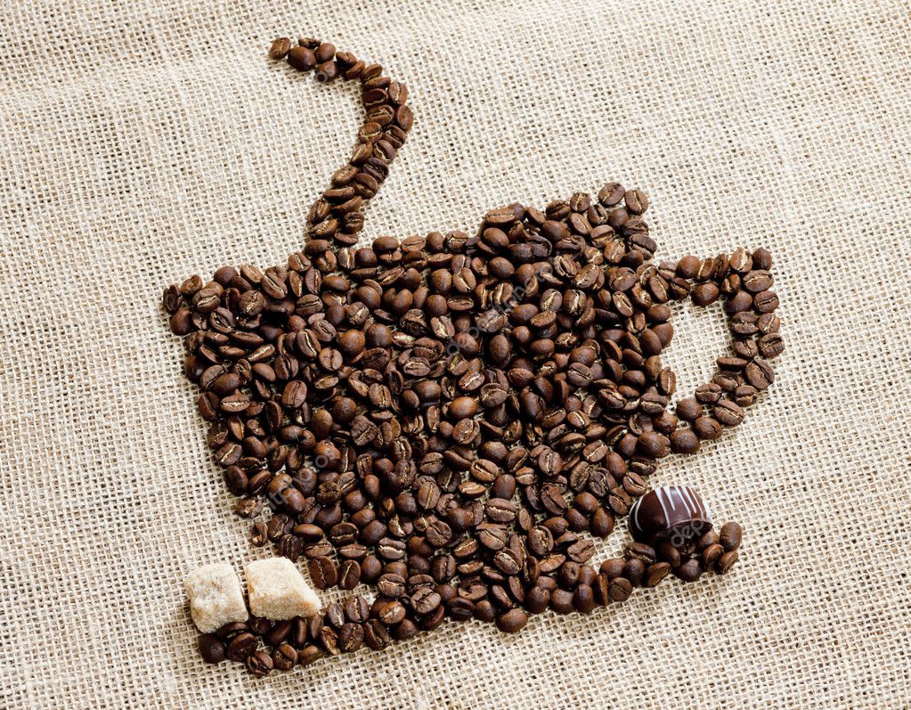 Cup of coffee made of coffee beans with sugar and chocolate Stock Photo