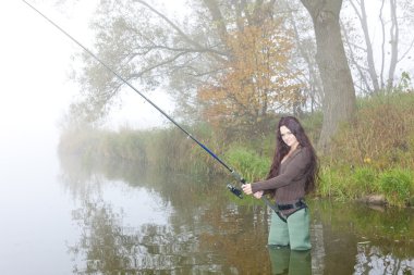 Woman fishing in pond clipart