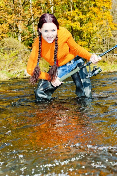 Woman fishing in Otava river, Czech Republic Stock Photo