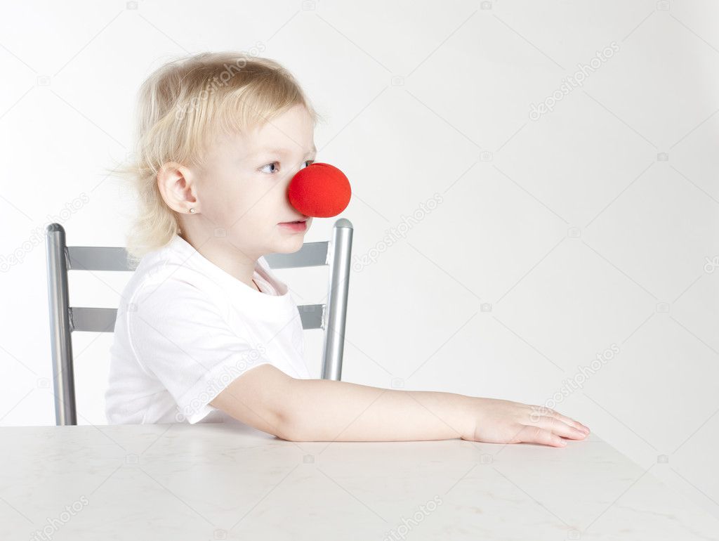 Portrait of little girl with a clown nose