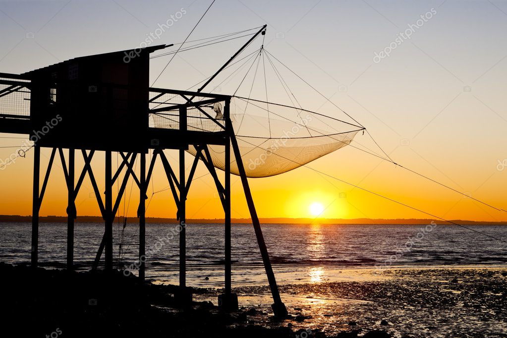 Pier with fishing net during sunrise, Gironde Department, Aquita